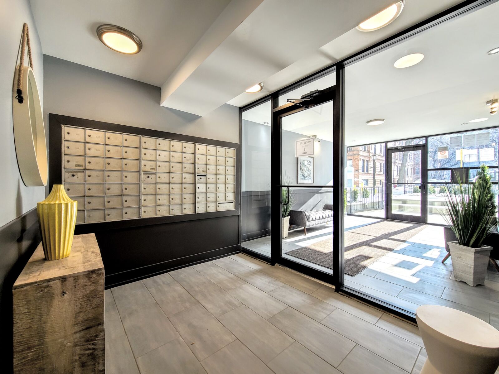 A modern apartment lobby at 530 W. Surf in Chicago's Lakeview neighborhood, featuring floor-...