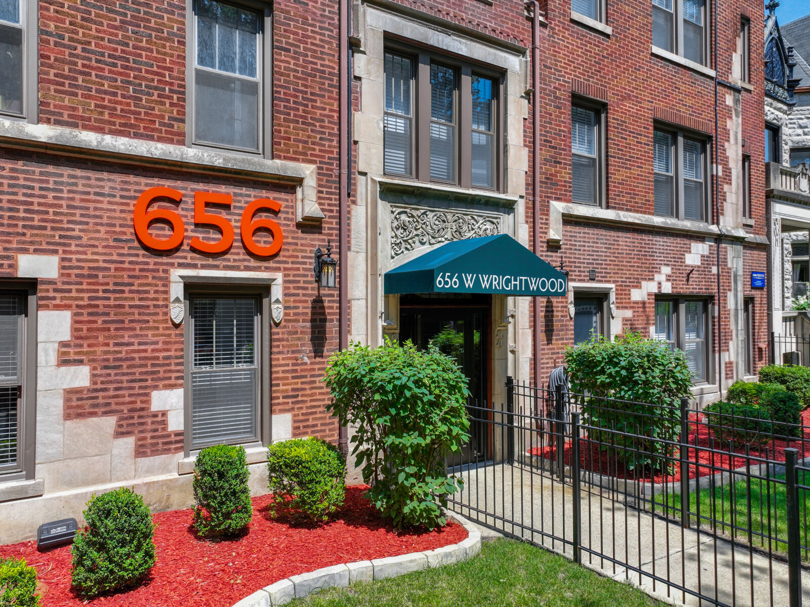Main entrance to a red brick apartment building at 656 W Wrightwood in Chicago’s Lincoln Park nei...