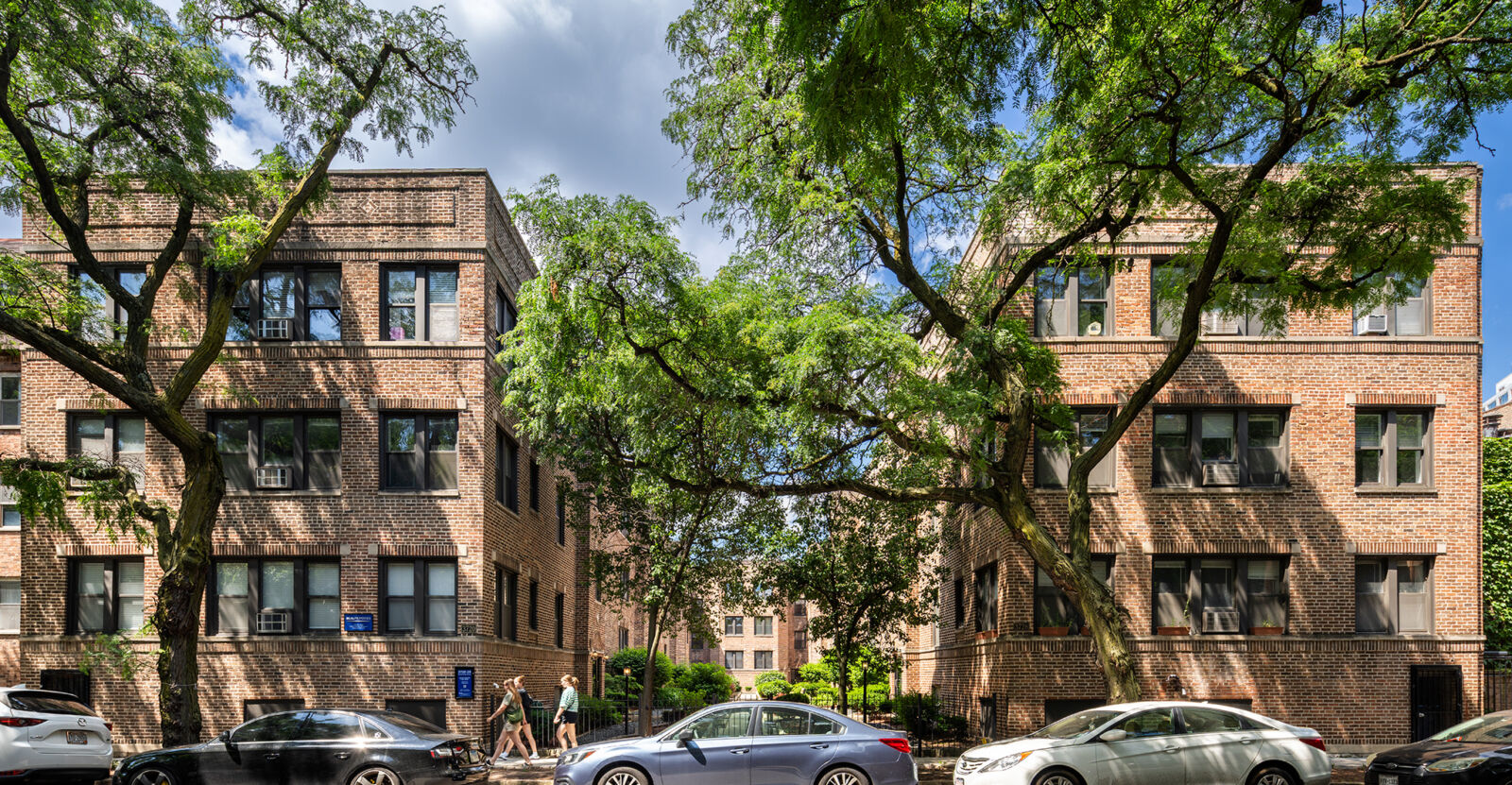 Two symmetrical red brick apartment buildings at 3720–3728 North Pine Grove in Chicago’s Wrigleyv...