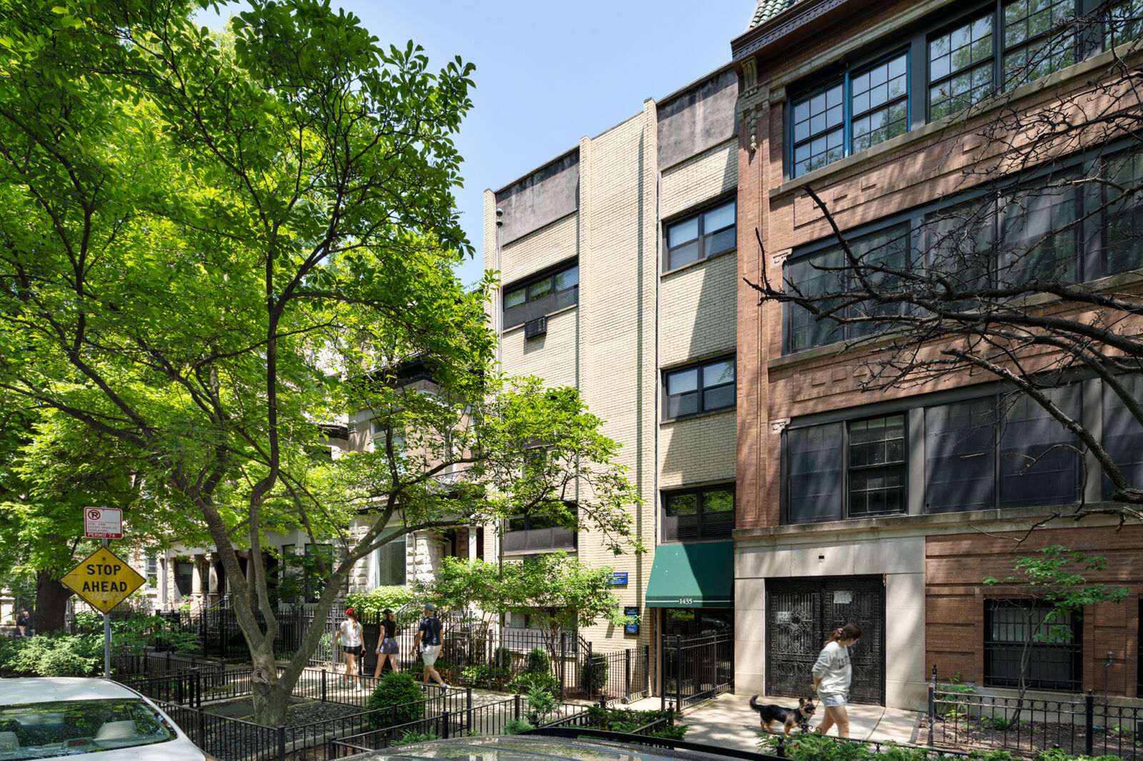Narrow cream brick apartment building with green awning at 1435 N Dearborn Parkway in Chicago’s G...