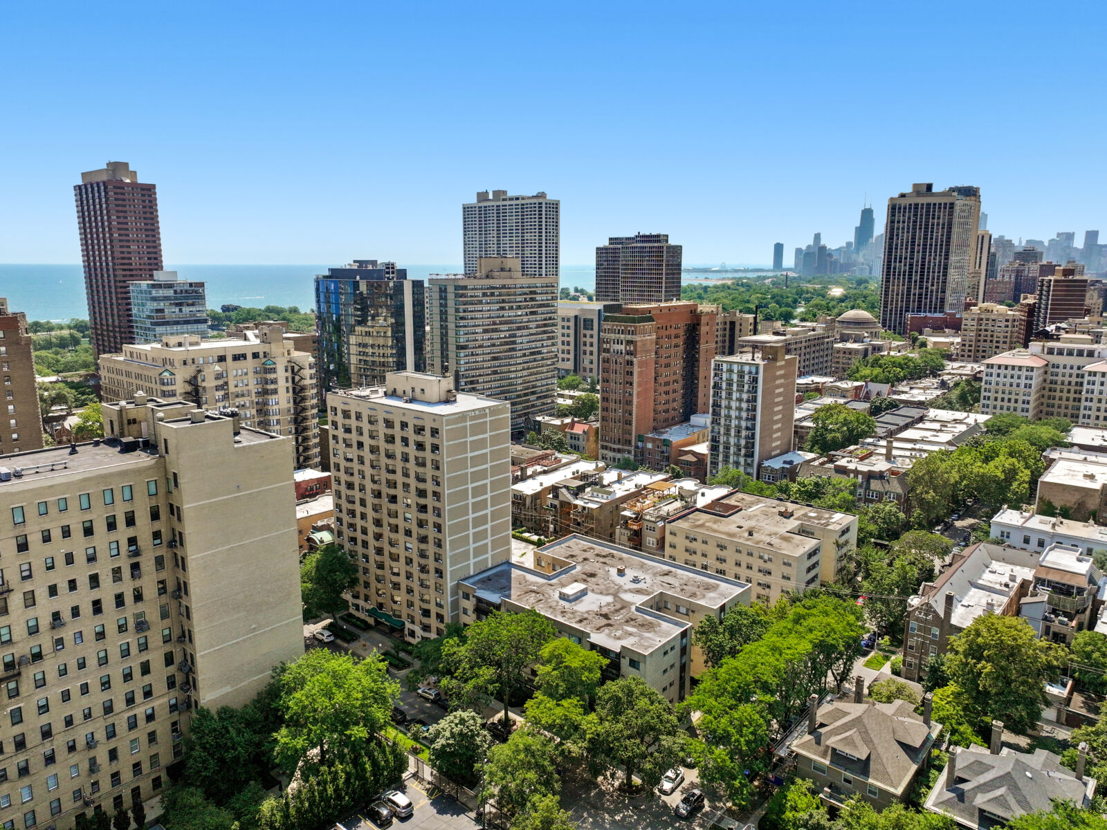 A beige brick high-rise apartment building at 445 W Wellington in Chicago, seen from above with n...