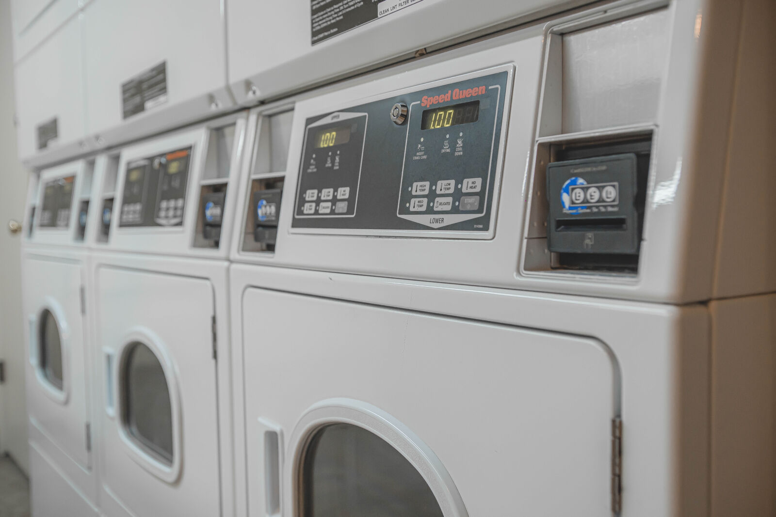 Rooftop deck with chain-link fence, two lounge chairs, and an outdoor sectional sofa facing the s...