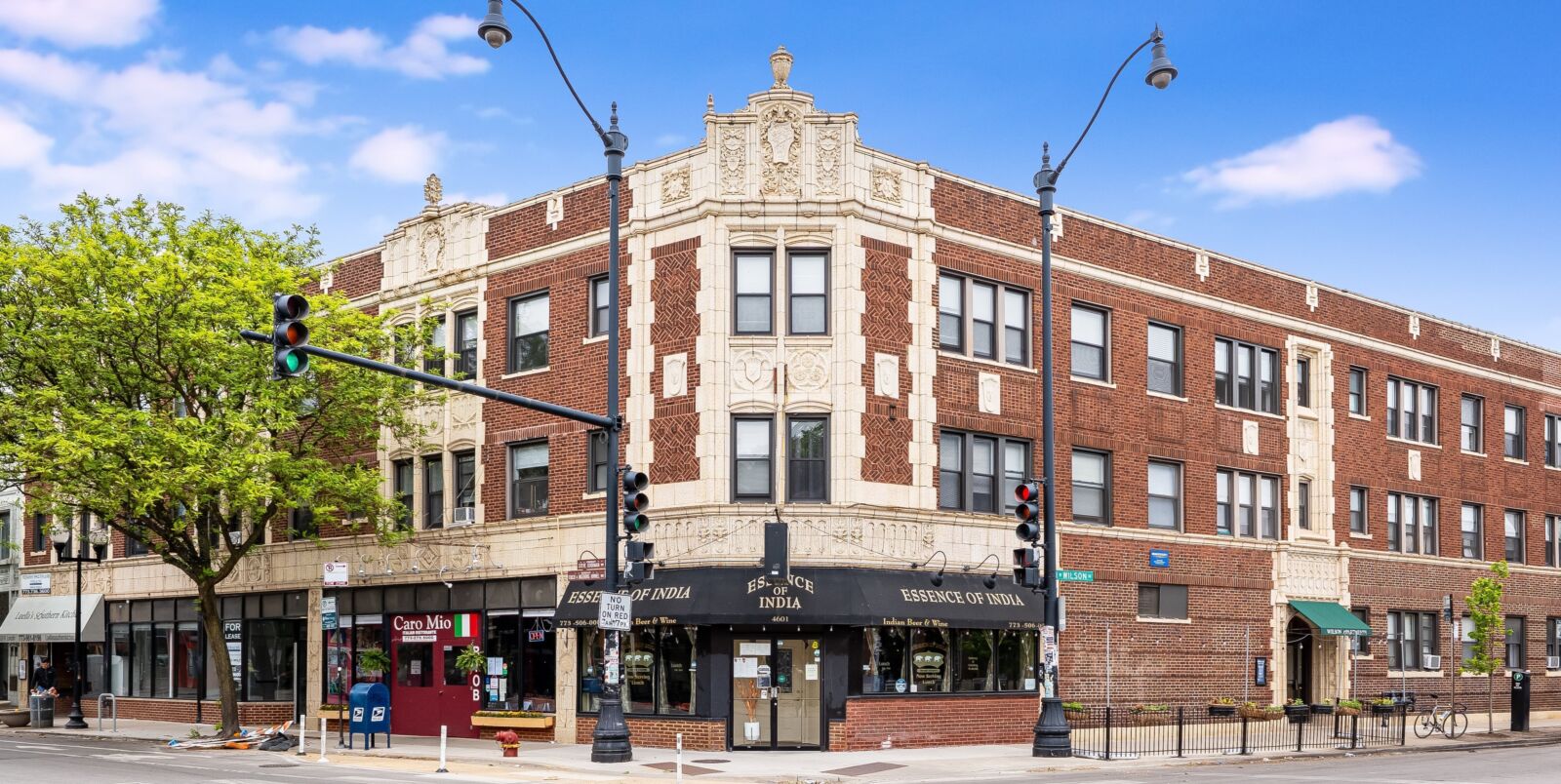 Vintage red brick apartment building with ornate limestone detailing at 4601–4609 N Lincoln Avenu...